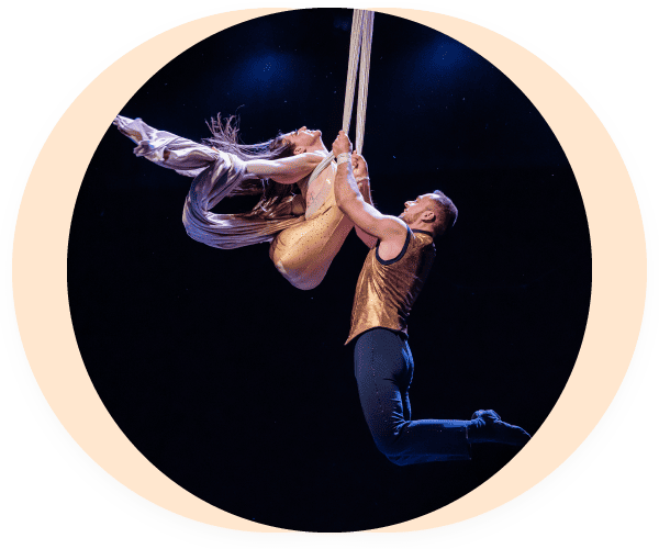 Performers Jen Bricker-Bauer and her husband Dominik perform on aerial silks.