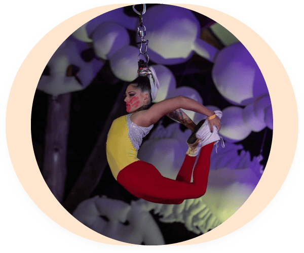 Performer Stephanie Morphet-Tepp hanging from her hair holding her feet behind her back